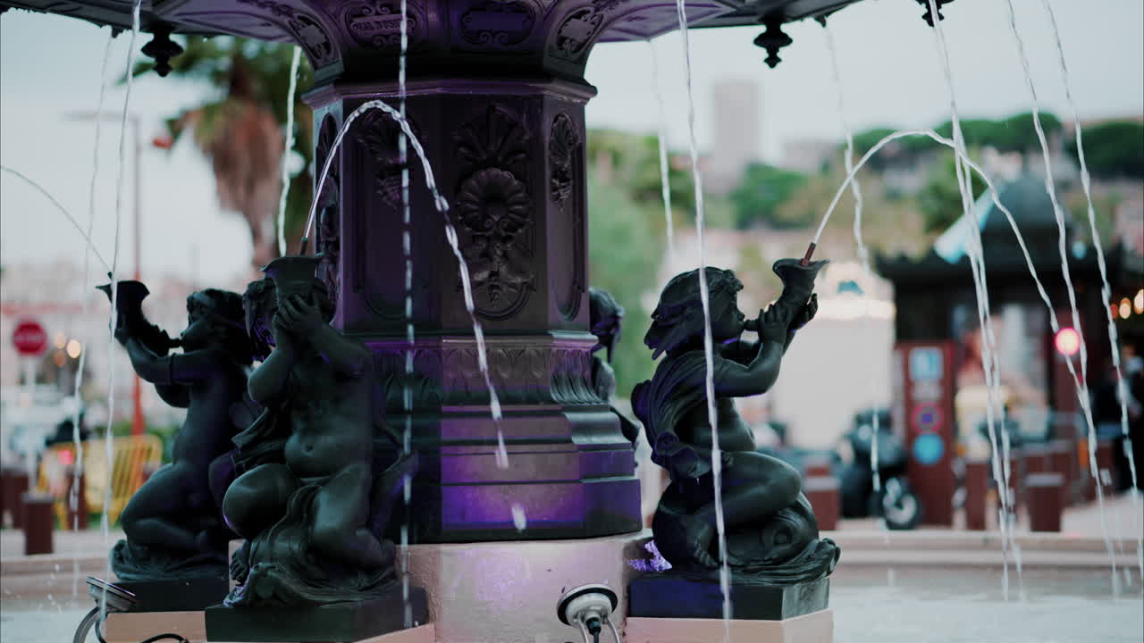 Close up of a water pouring in a fountain with a blurry background in Cannes, France