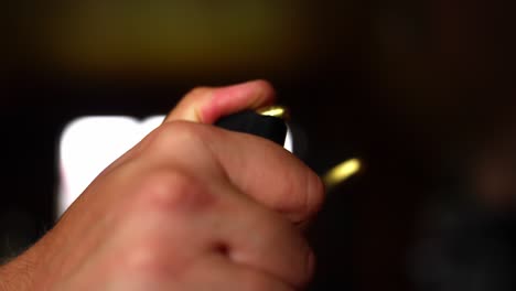 ammunition removed from pistol magazine in slow deliberate motion under dim lighting, side view