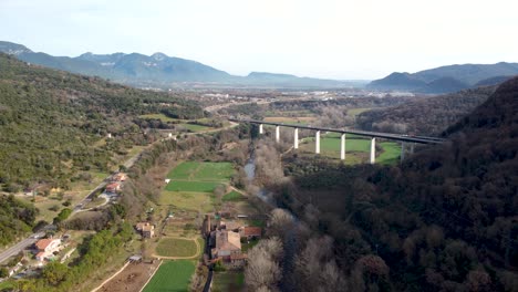 aerial drone view from castellfollit de la roca: the cliffside town in girona’s pyrenees, near garrotxa volcanic zone