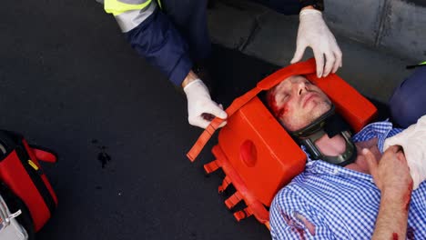 emergency medical technician protecting the head of his wounded person