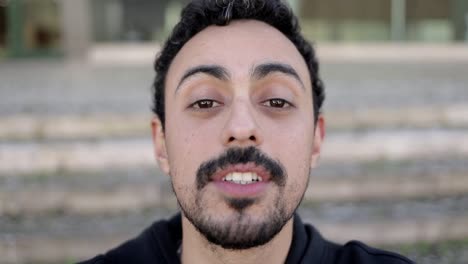 Man-talking-and-smiling-at-camera-during-video-chat