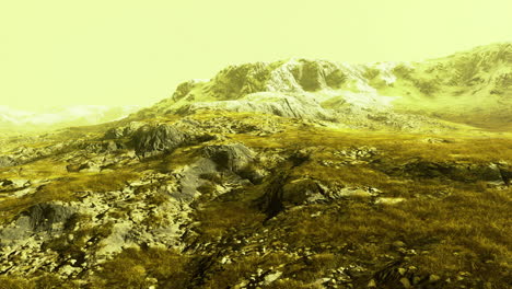 mountain landscape under a yellow sky during serene daylight hours
