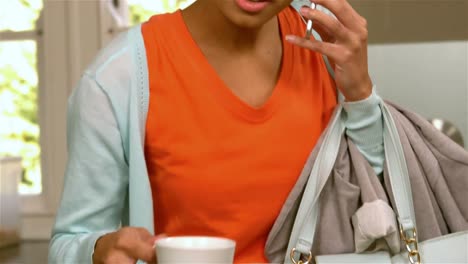 Pretty-woman-on-a-phone-call-holding-cup