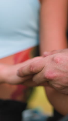 loving man and woman join hands and lady strokes leg thigh of boyfriend sitting together at romantic date on spring day close view slow motion