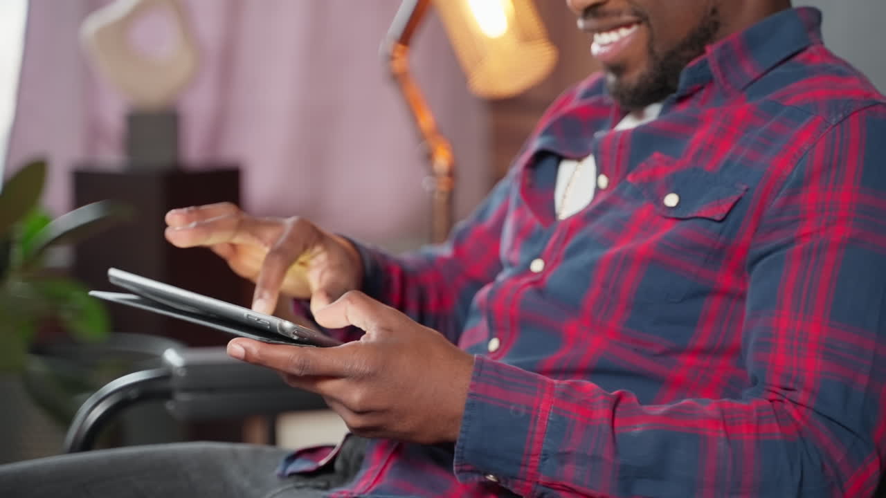 Man using a tablet in a living room