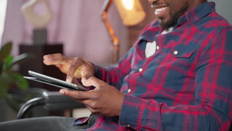 man using a tablet in a living room