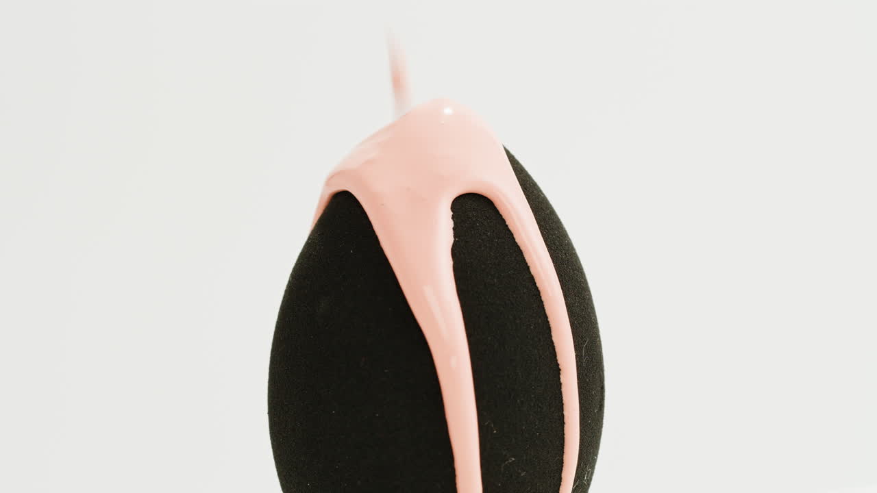 Pink Liquid Dripping onto a Makeup Sponge
