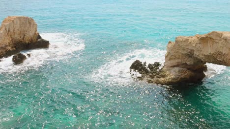stunning view of the natural rock formations, including the iconic love bridge arch, along the vibrant turquoise coast of cyprus