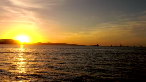 stunning sunset over the ocean with sailboats