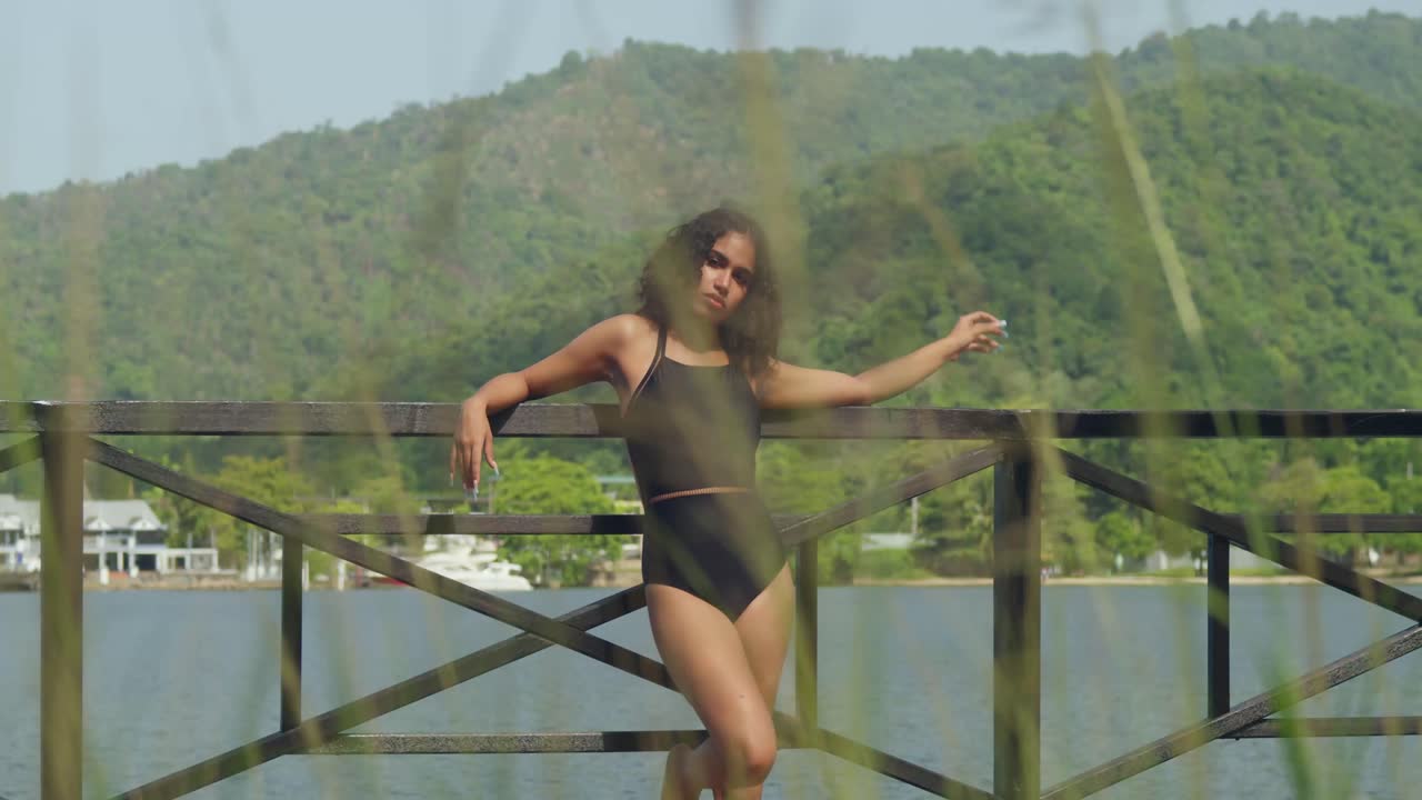 The Caribbean sun shines down on a girl in a bikini as she enjoys a day by the boardwalk and beach.