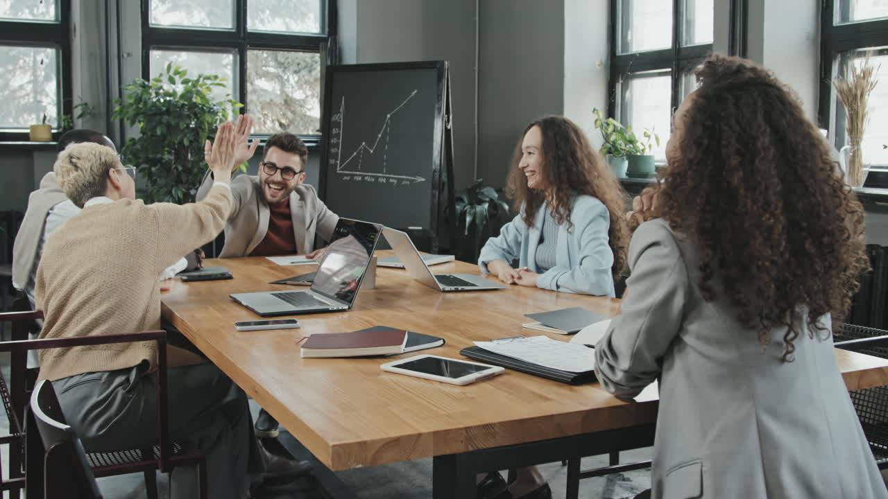 Cheerful Coworkers Celebrating Successful Investment