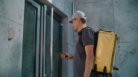 courier delivering package to customer at modern apartment entrance