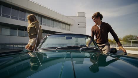 couple in a vintage convertible car