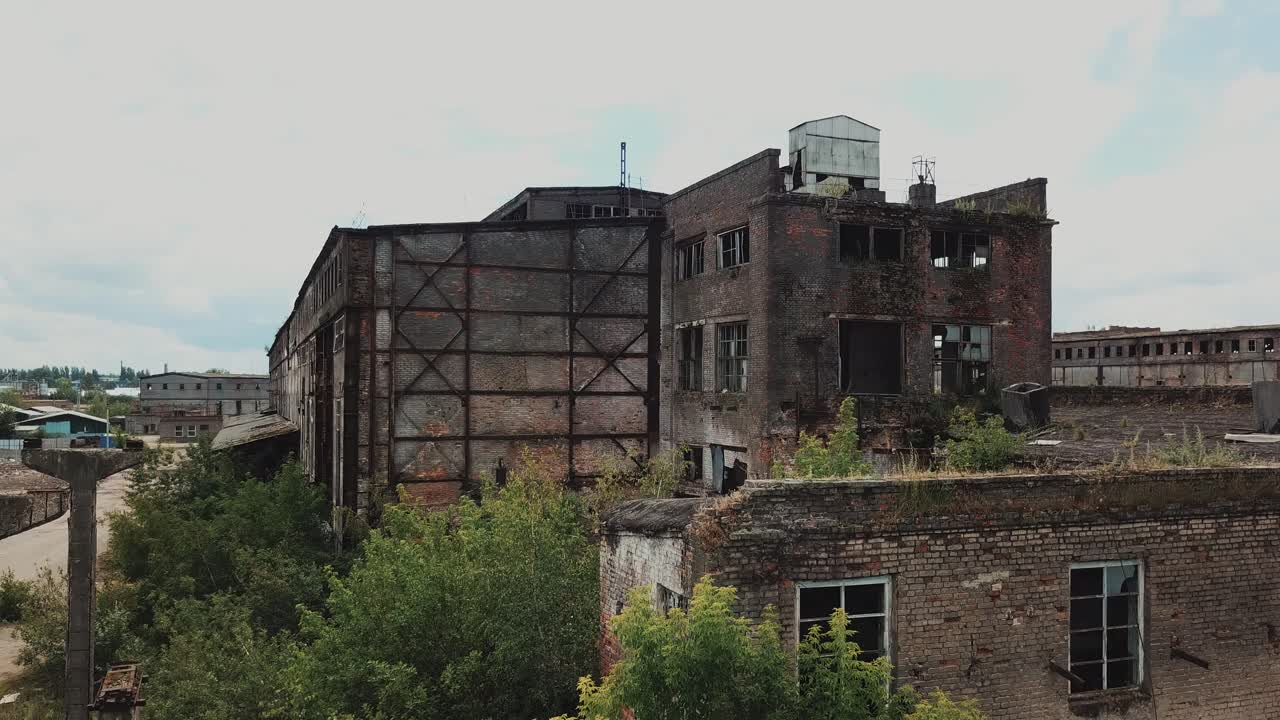 Aerial view from the air to an abandoned factory. Old industrial building for demolition.