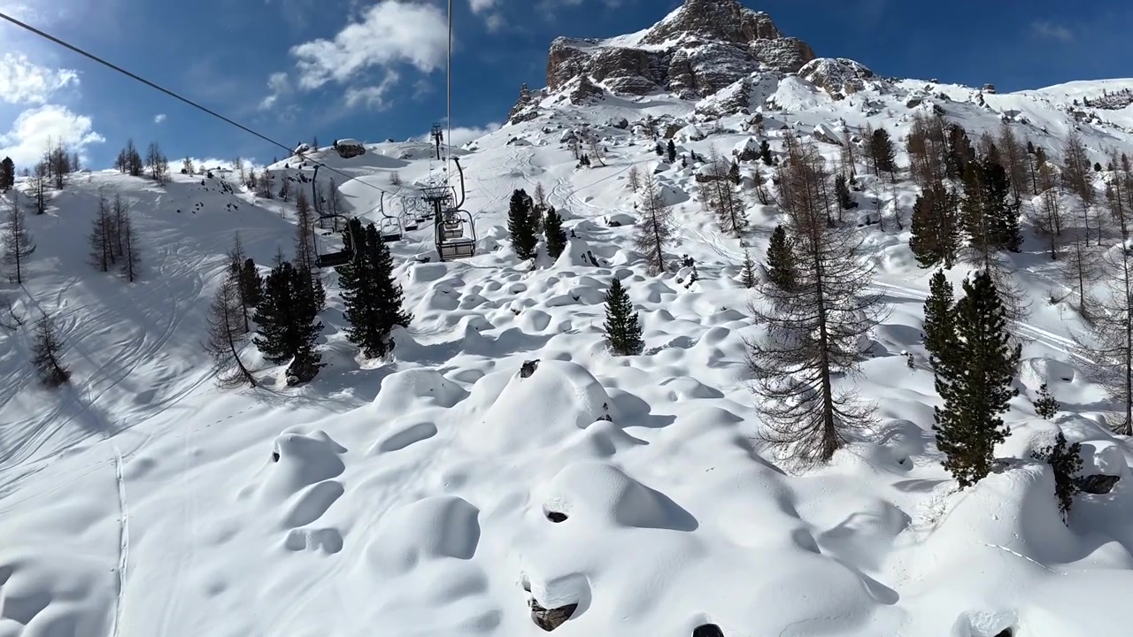 Chairlift Ride Over Snowy Mountain Landscape in the Alps