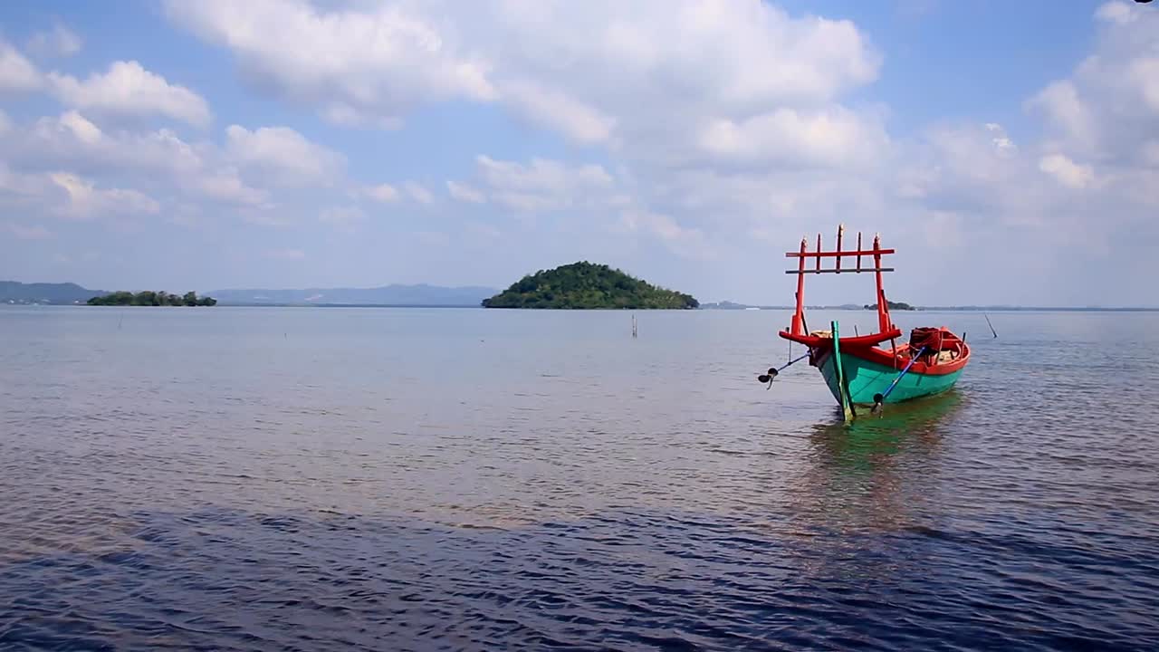 Ambient motion of a traditional khmer fishing boat peacefully floating in the gentle waves off the coast in Koh Sdach Island, Cambodia