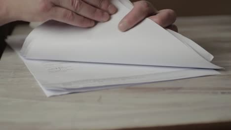 Looking-through-piles-of-papers-on-a-desk