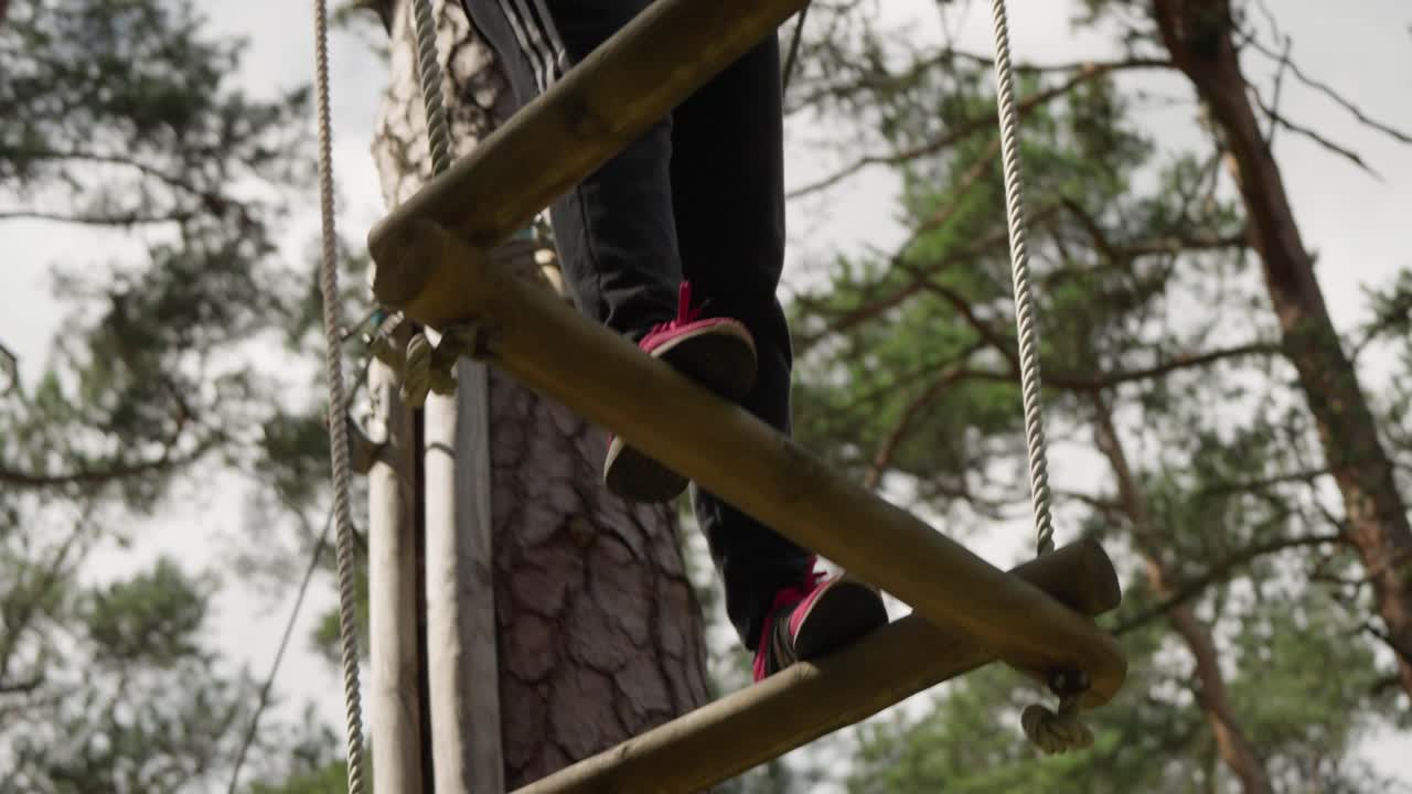 Feet of Person Walking on Wooden Steps in a High Ropes Course