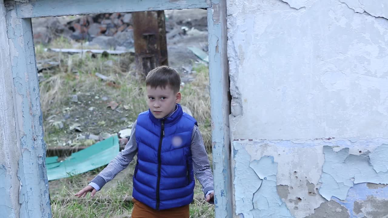 Lonely Boy Wandering In Ruins. Lonely boy wandering in ruins of the destroyed building or premises