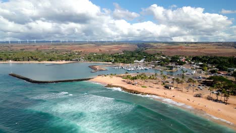 aerial view of ocean coast, overlooking of marina with moored yachts and boats in oahu, hawaii - drone shot