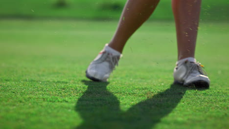 healthy sportswoman play golf on green field course. golfer hitting ball outside