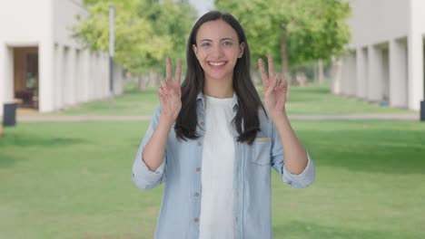 happy indian girl showing victory sign