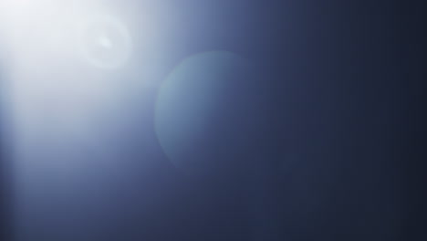 soft blue lens flare with a gentle light gradient across a clear black background. ideal for overlays, transitions, visual effects, or adding atmosphere to creative projects