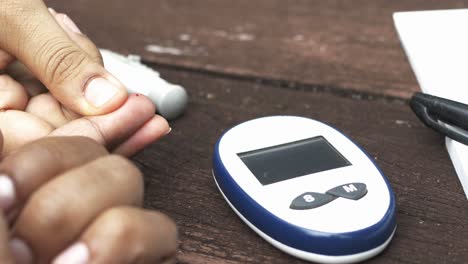 Young-mans-hand-measure-glucose-level-at-home