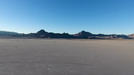 flying over the bonneville salt flats in northwestern utah reveal white salt and tire tracks