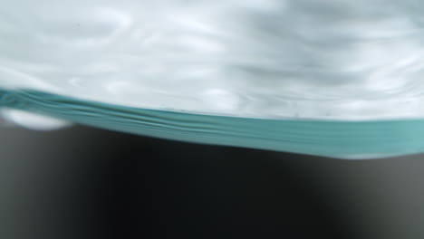 macro shot of the edge of a glass filled with water