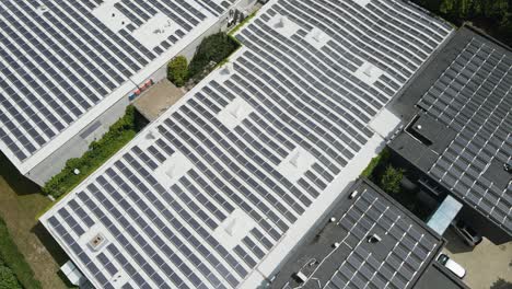 Beautiful jib down of an office rooftop filled with photovoltaic solar panels on a sunny day