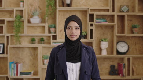 portrait of lovely young muslim business woman wearing hijab headscarf looking confident smiling calm