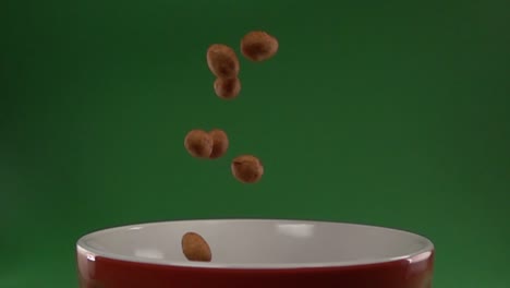 japanese style peanuts slowly falling on a plate