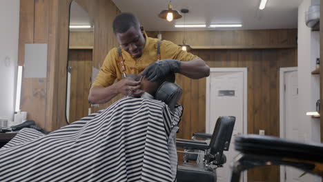 barber shaving client's face