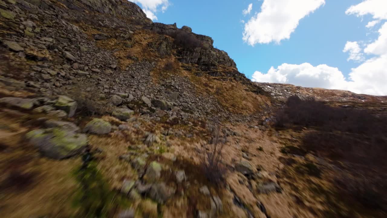 Cruising fast up rocky Dolomite slope, FPV drone view, thrilling mountain ride