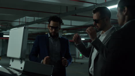 businessmen investigating in an underground parking garage