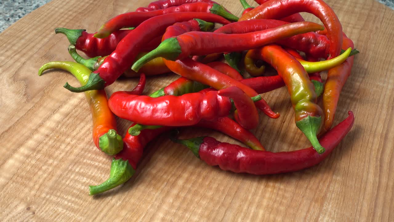 Red chilli, pepper. Shooting in the movement. Shooting in kitchen