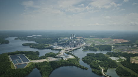 wide aerial hyperlapse during the day of a power plant on hyco lake, north carolina