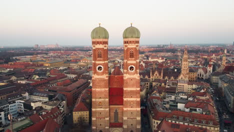 aerial closing to the munich frauenkirche, rathaus, alter peter and innenstadt, showcasing its two towering spires with awe-inspiring grandeur