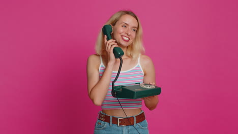 Young-woman-talking-on-wired-landline-vintage-telephone,-advertising-proposition-of-conversation