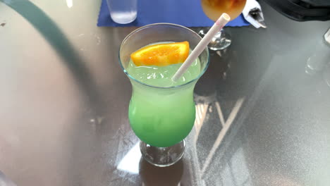 pretty green cocktail on a glass table