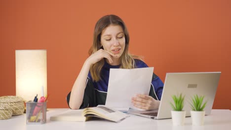 The-young-woman-examining-the-files-approves-the-files-with-her-head.