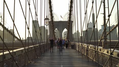 usa flag waving in the wind on the top of brooklyn bridge in new york