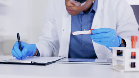 hands, blood and writing in a lab for science