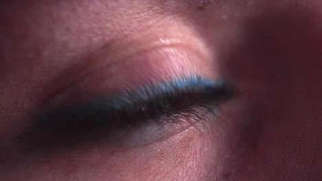 reflection of screen on person's blue green eye in dark room 21