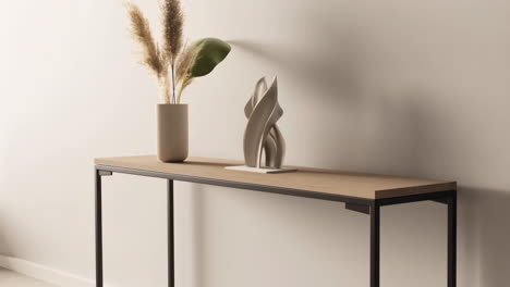 modern console table decor with pampas grass and abstract sculpture