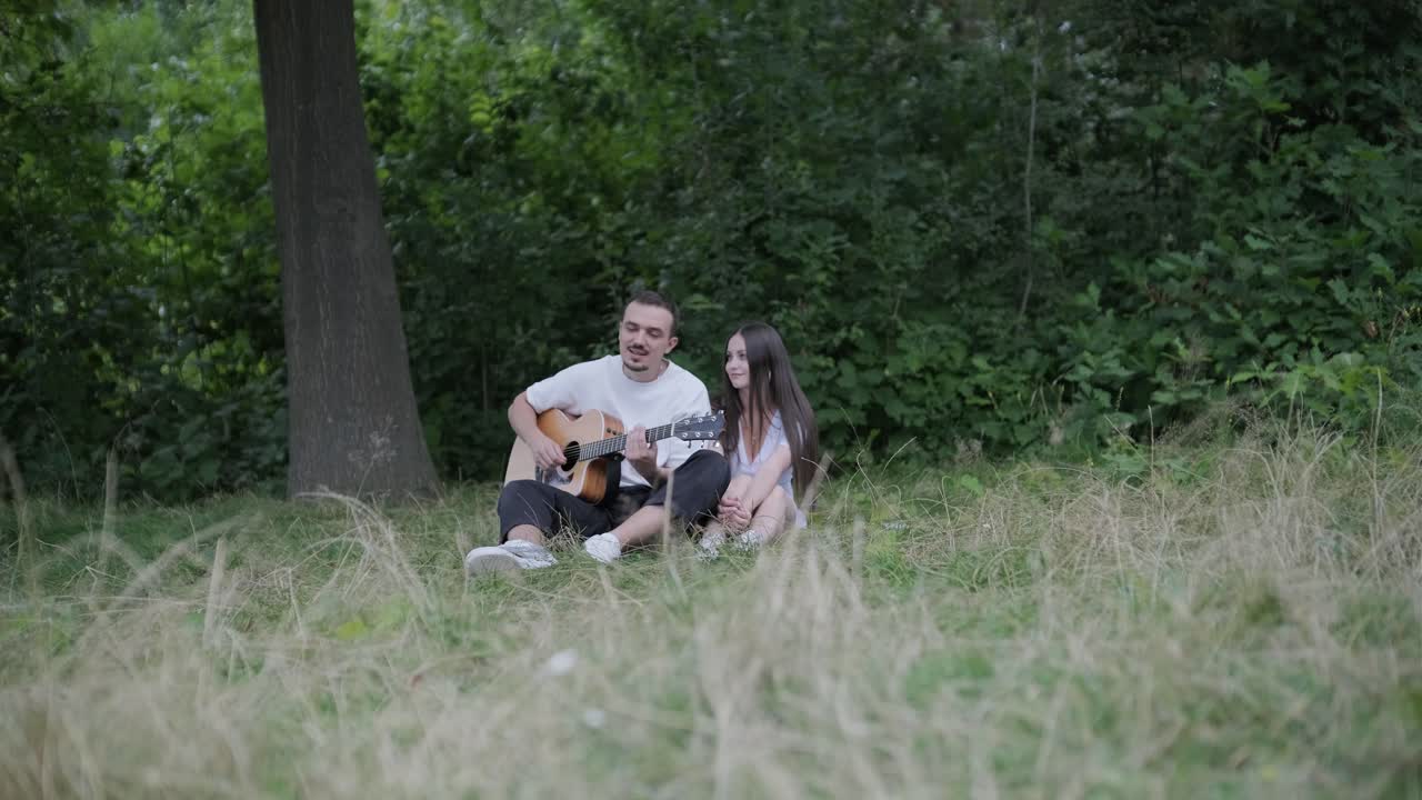 Couple enjoying music in the forest