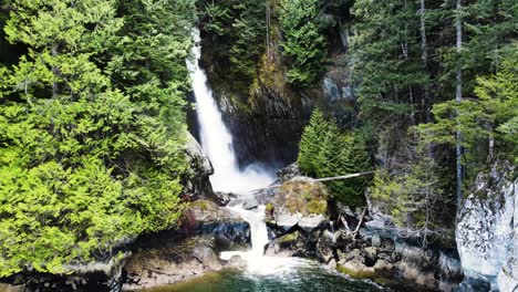 aerial pullback shot of silver falls in british columbia, canada