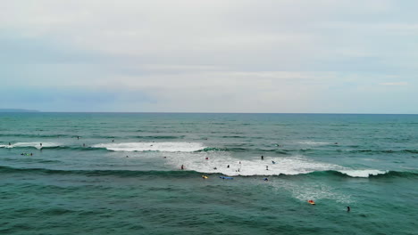 crowd of people surfing on turquoise waters