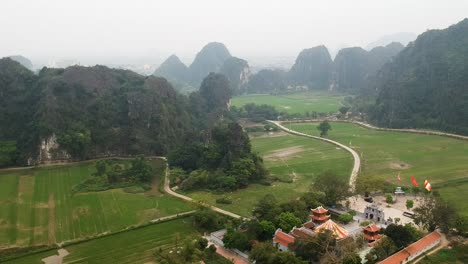 aerial view of vietnamese countryside, limestone rocks and thai vi temple in tam coc, ninh binh, vietnam